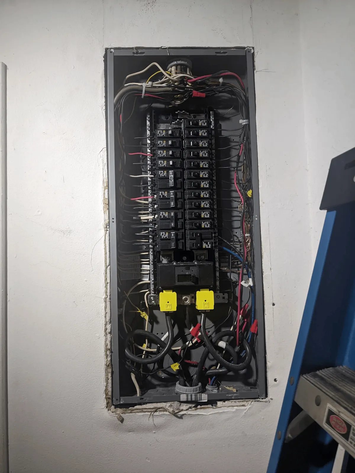 Open breaker panel showing new breakers and dressed branch-circuit wiring