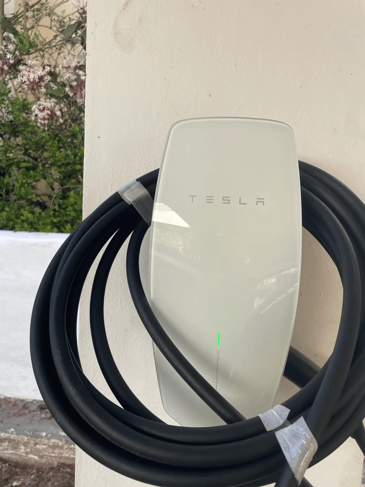 Level 2 electric vehicle charger mounted on a home wall with dedicated circuit