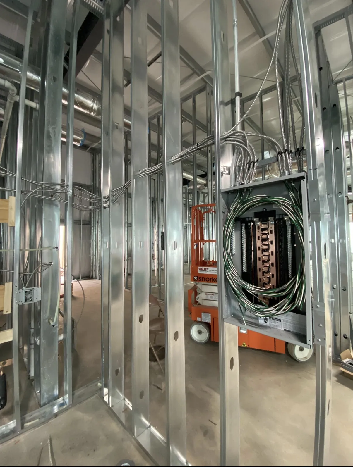 Rough-in wiring and conduit run through steel-stud framing