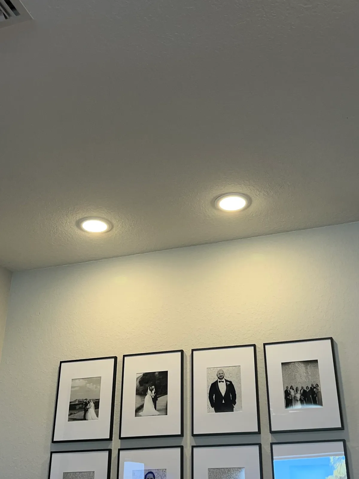 Evenly spaced pot lights installed in a family room ceiling
