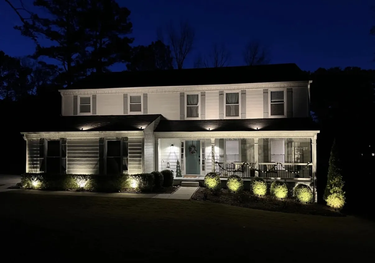 Exterior and landscape lighting illuminating a residential home at night