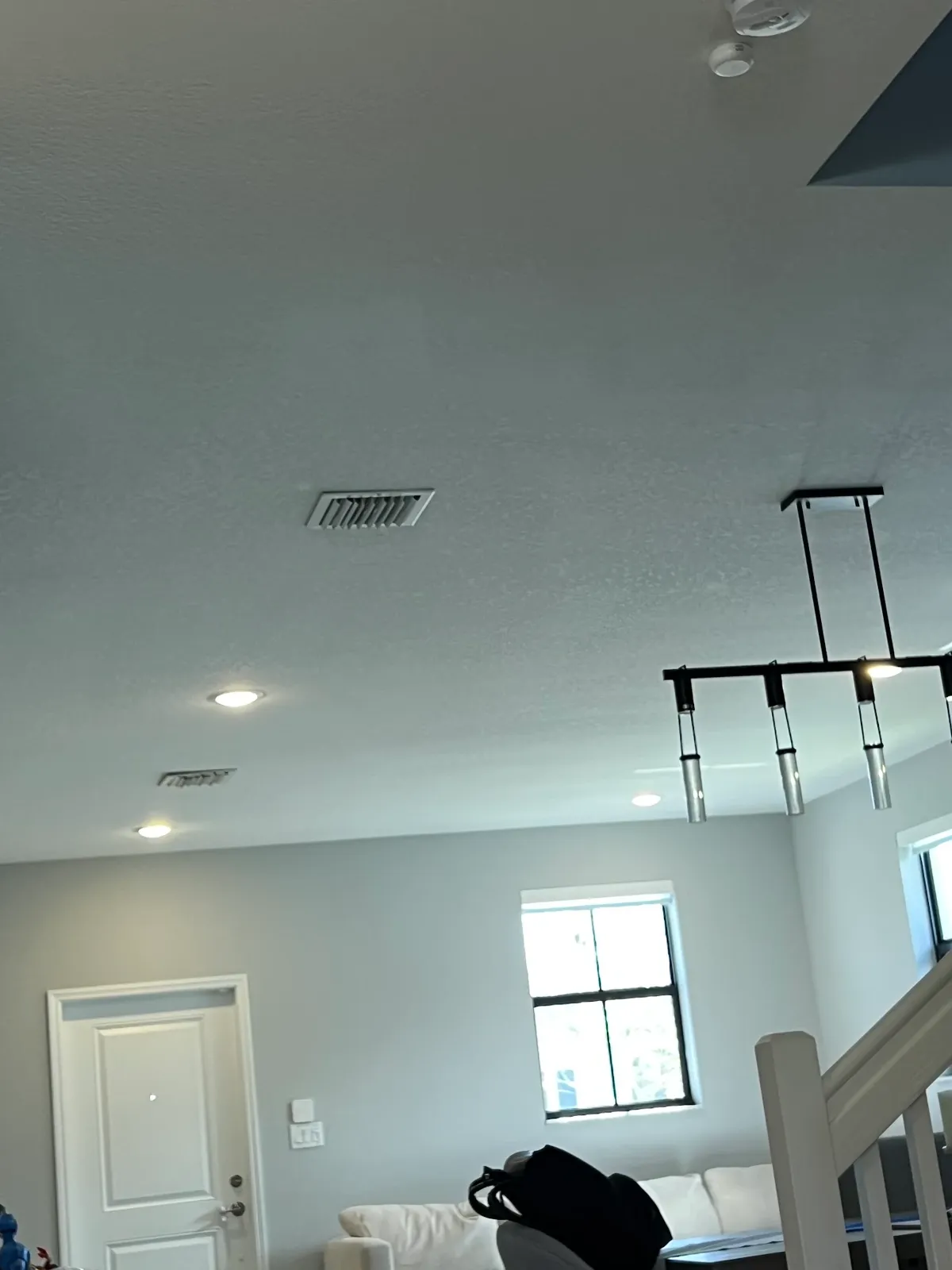 Kitchen pot lights and a ceiling fixture installed over the work area
